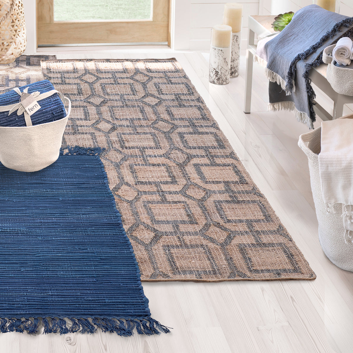 Lifestyle, showing the Fern Jute Runner leading to a doorway and the upcycled rag rug next to it for a splash of deep blue color.