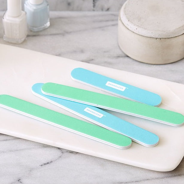 Lifestyle photo, emery boards sitting on a tray on a bathroom counter.