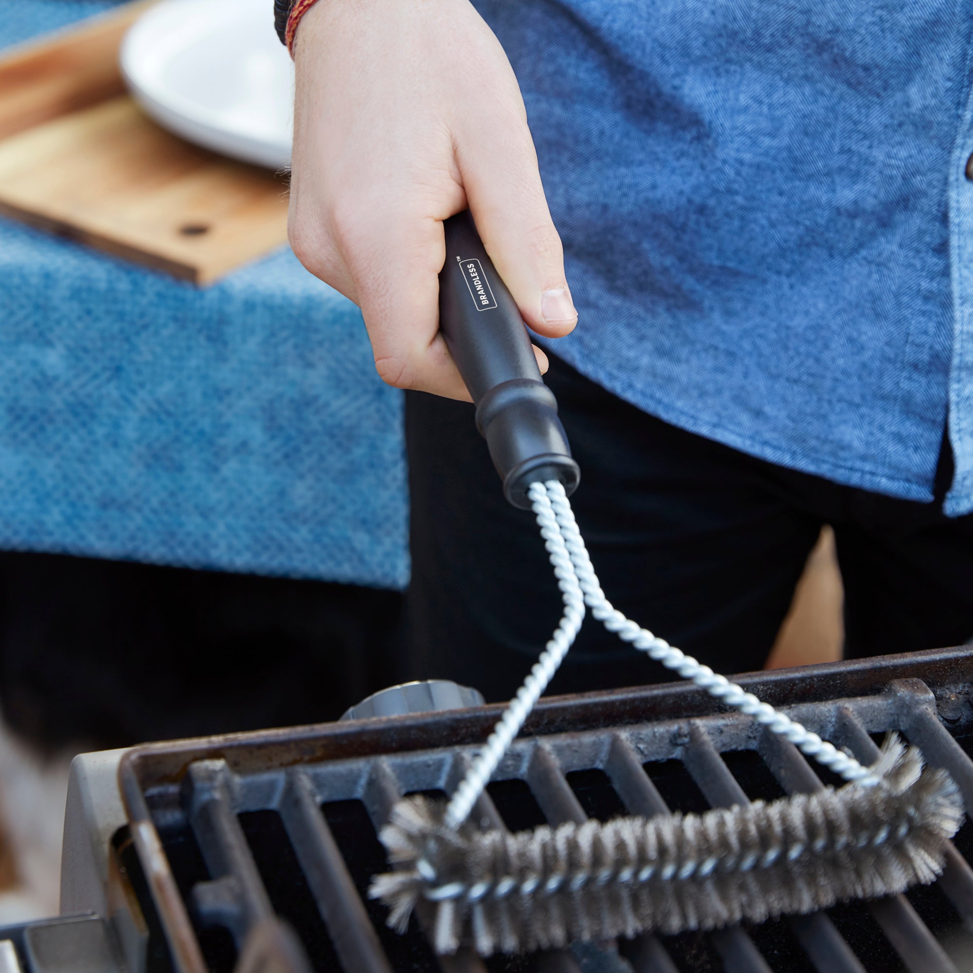 Lifestyle photo, man cleaning a grill