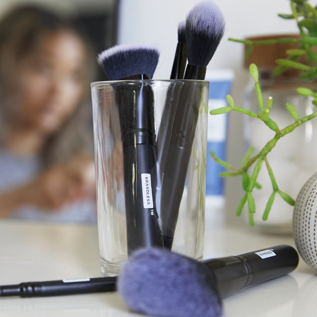 Lifestyle, set of brandless makeup brushes on a bathroom counter and in a glass container.